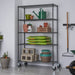 Trinity TBFPBA-0924 (48x18x72) PRO 5-Tier Wire Shelving w/ Wheels in Black Anthracite Color. Shown with common gardening tools. View from the front right.