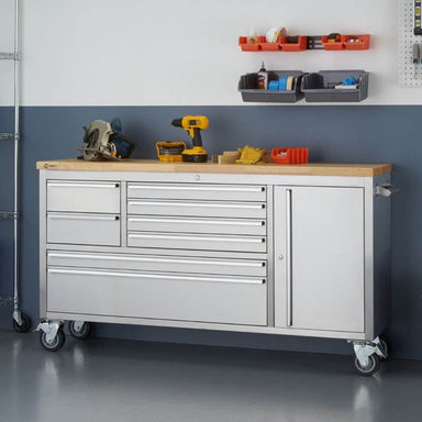 Trinity TLS-4813 (66x19) Stainless Steel Rolling Workbench with Worktop Being Used. Viewed from the Front Right and shown next to a wall.
