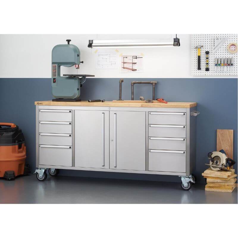 Trinity TLS-7204 (72x19) Stainless Steel Rolling Workbench Against a Wall. Worktop is being used for renovation tools.