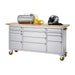 Trinity TLSF-7209 (72x19) PRO Stainless Steel Rolling Workbench Shown with an Air Compressor and Motorcycle Helmet on the Worktop. Viewed from front right and with a white background.