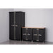 Trinity TSNPBK-0615 (4-Piece) PRO Garage Cabinet Set in Black Placed Against a Wall in a Garage with Drawers Closed with Nothing on Worktop.